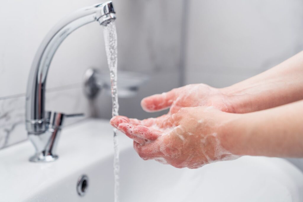 A person washing their hands.