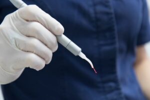 Dental professional holding a dental laser